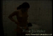A naked red-haired girl in a tiled bathroom squats on the floor and shits next to a pair of black platform heels, with close-ups as it comes out, then shows it off in a glass jar. Over 2 minutes.